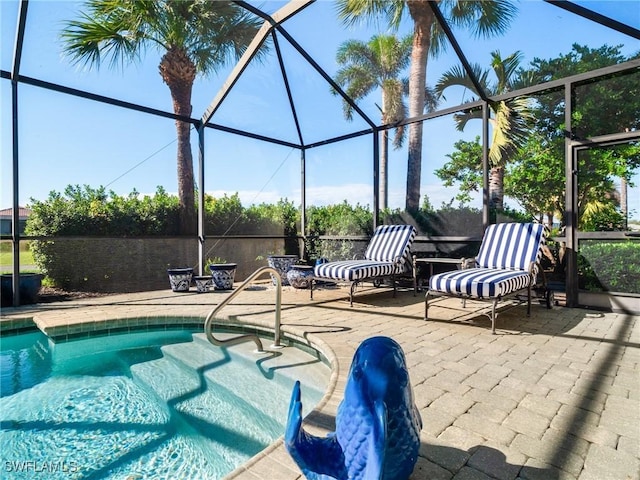 view of pool featuring a patio area and glass enclosure