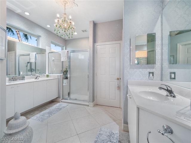 bathroom with tile patterned flooring, vanity, an enclosed shower, and a notable chandelier