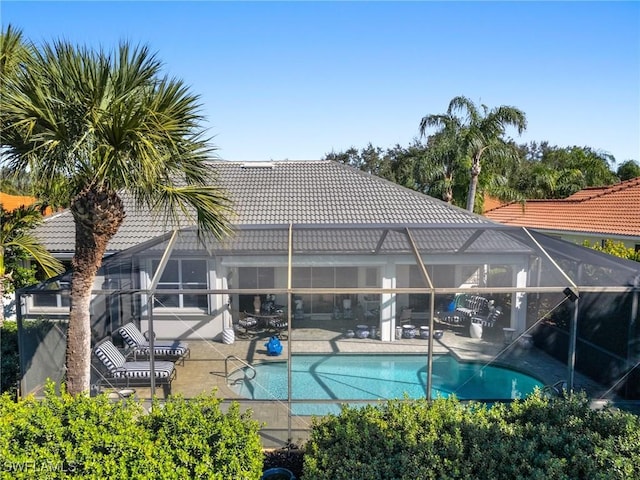 view of swimming pool featuring a lanai and a patio