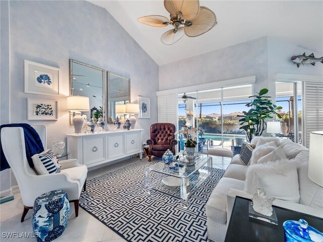 tiled living room featuring ceiling fan and high vaulted ceiling