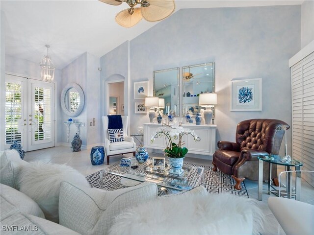 living room featuring high vaulted ceiling and french doors