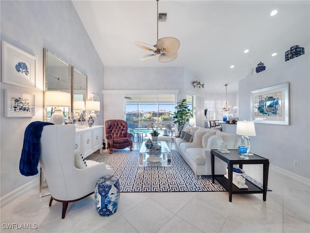 living room with ceiling fan, light tile patterned floors, and vaulted ceiling