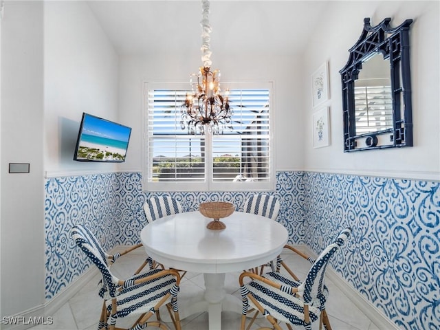 tiled dining area with breakfast area, a chandelier, and plenty of natural light