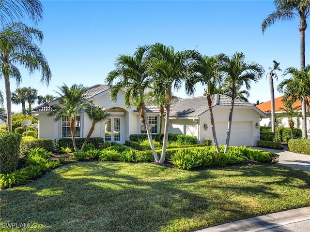 view of front of home featuring a garage and a front lawn