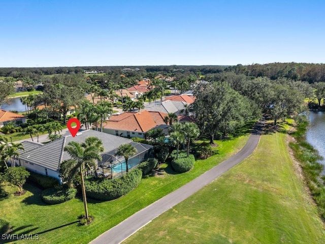 birds eye view of property with a water view