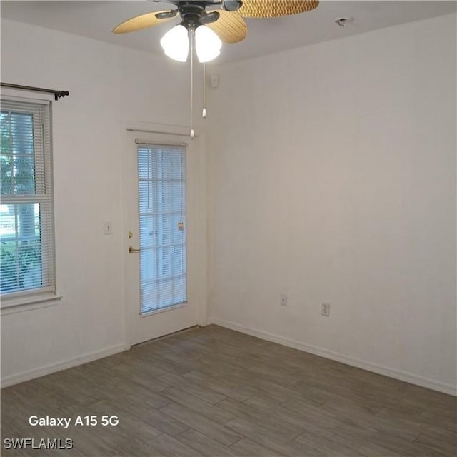 empty room featuring ceiling fan and dark hardwood / wood-style flooring