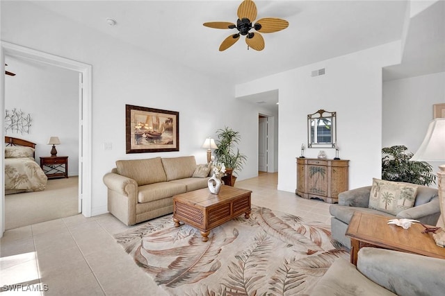 tiled living room with ceiling fan