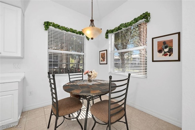 dining space featuring light tile patterned flooring