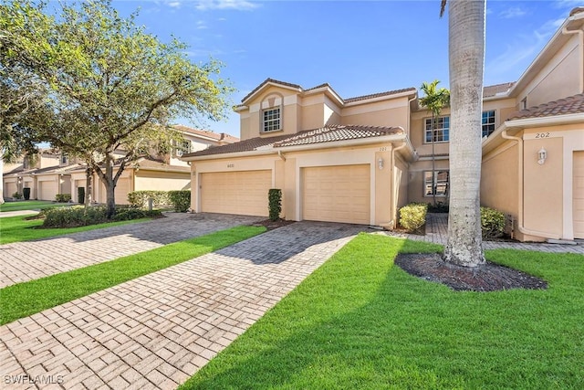 view of front of property featuring a garage and a front yard