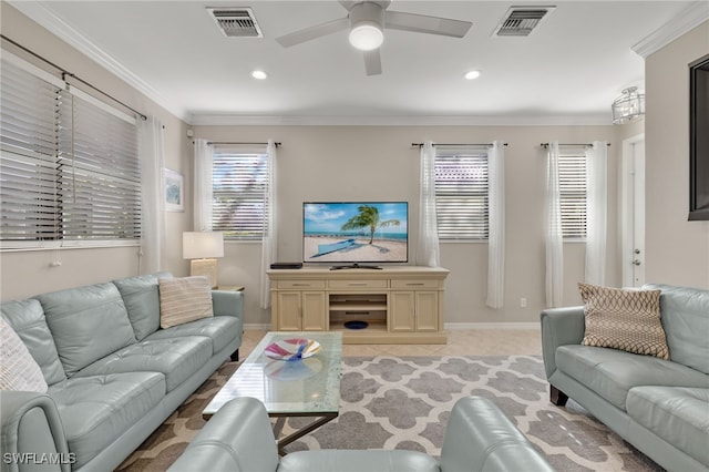 tiled living room featuring ceiling fan, crown molding, and a healthy amount of sunlight