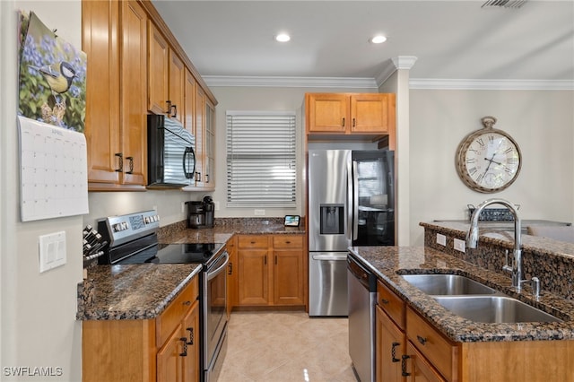 kitchen featuring light tile patterned floors, appliances with stainless steel finishes, dark stone counters, crown molding, and sink