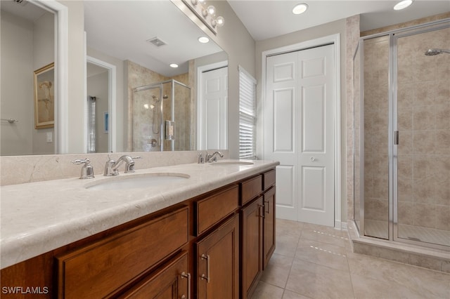 bathroom with vanity, tile patterned flooring, and a shower with door