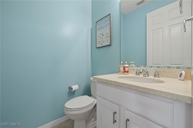 bathroom with toilet and vanity