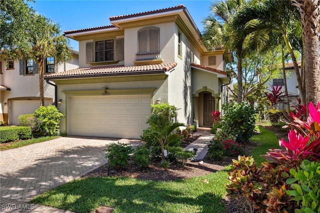 mediterranean / spanish-style house with a garage