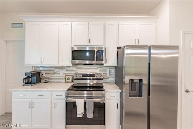 kitchen with light stone counters, stainless steel appliances, visible vents, white cabinetry, and tasteful backsplash