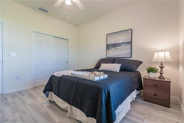 bedroom with a closet, visible vents, ceiling fan, and baseboards