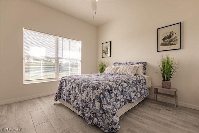 bedroom featuring light wood-style flooring and baseboards