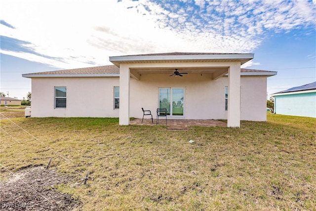 back of house featuring a yard, a patio area, ceiling fan, and stucco siding