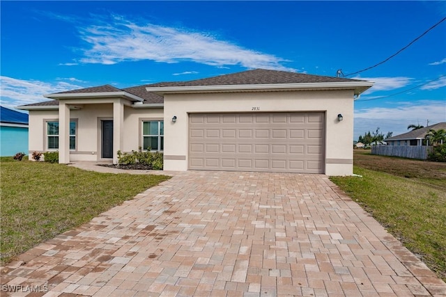 view of front of house featuring a front yard, decorative driveway, and stucco siding