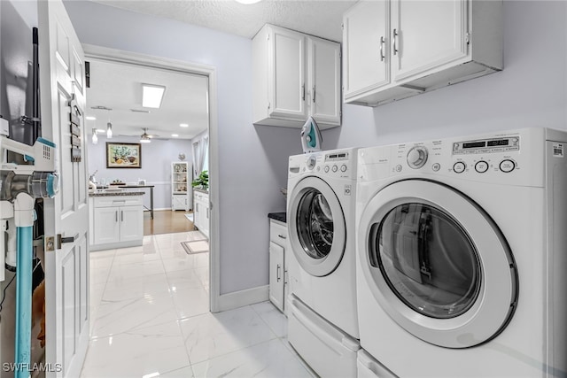 washroom with separate washer and dryer, ceiling fan, cabinets, and a textured ceiling