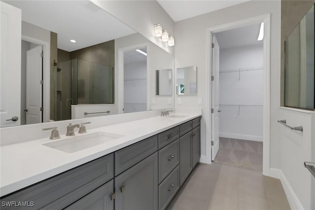 bathroom featuring tile patterned flooring, vanity, and an enclosed shower