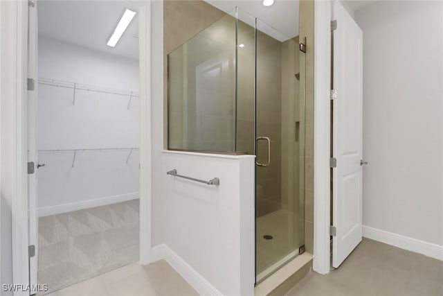 bathroom featuring a shower with shower door