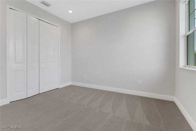 unfurnished bedroom with a closet and carpet