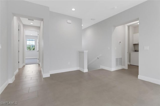 tiled spare room featuring washer / clothes dryer