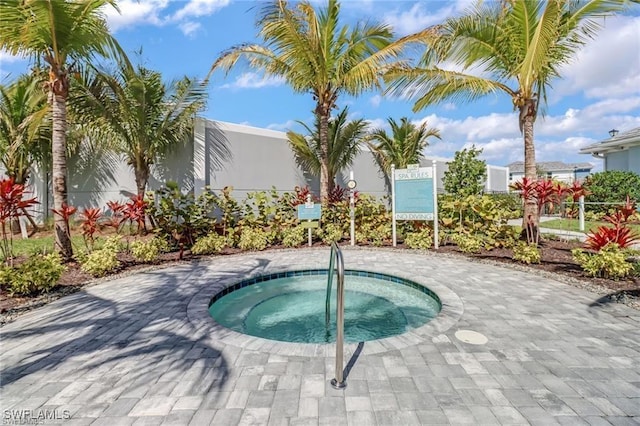 view of swimming pool with a community hot tub