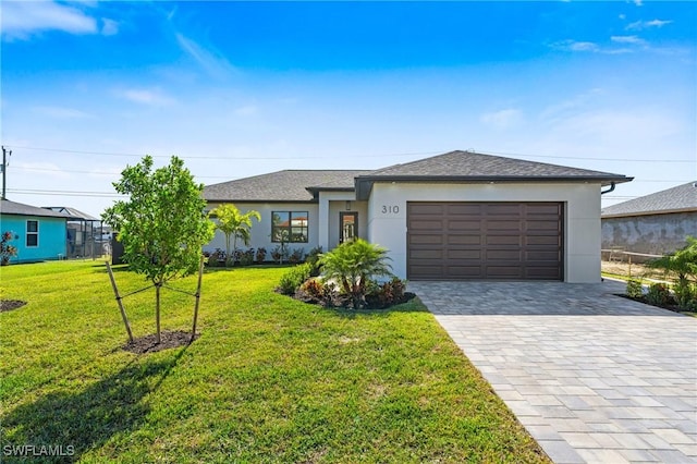 view of front of house with a garage and a front yard