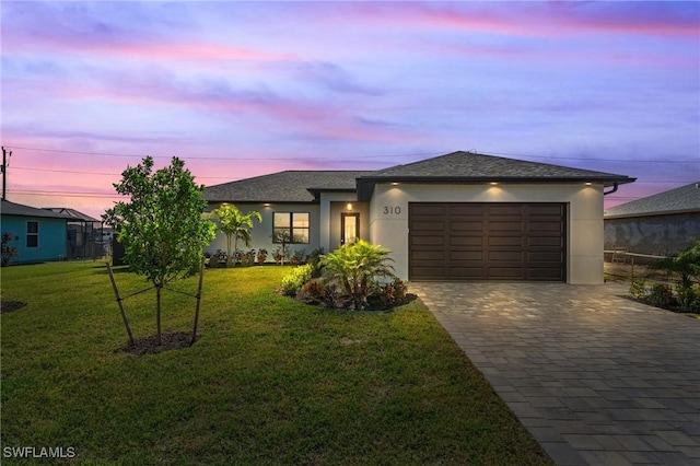 view of front facade with a lawn and a garage