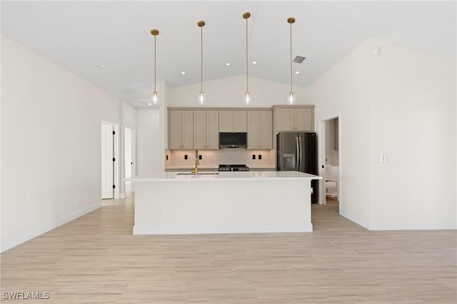 kitchen with an island with sink, sink, and decorative light fixtures