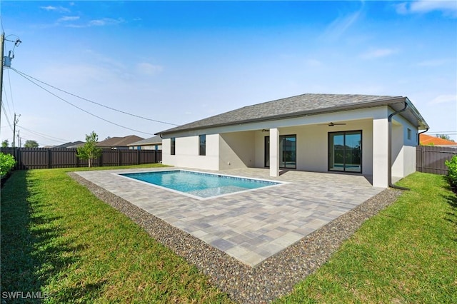 view of swimming pool featuring a lawn, ceiling fan, and a patio area