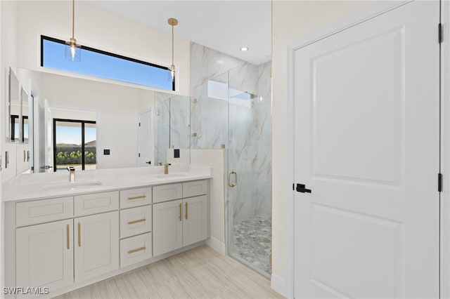 bathroom with vanity and a shower with shower door