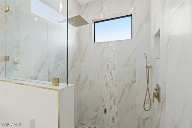 bathroom with a tile shower