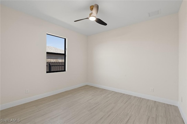 spare room featuring light hardwood / wood-style flooring and ceiling fan