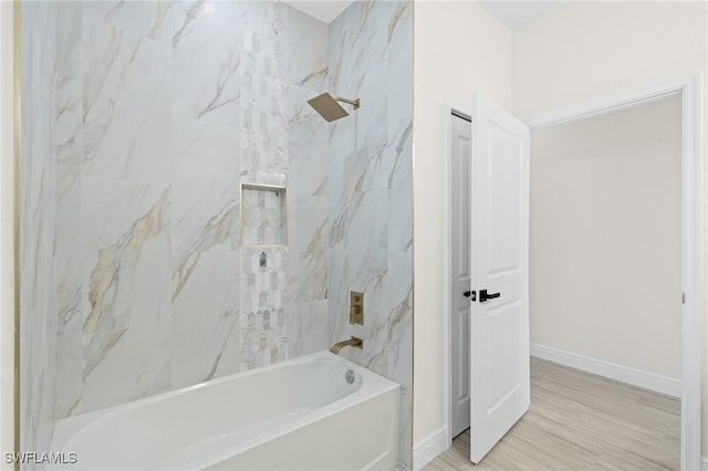 bathroom featuring hardwood / wood-style flooring and tiled shower / bath