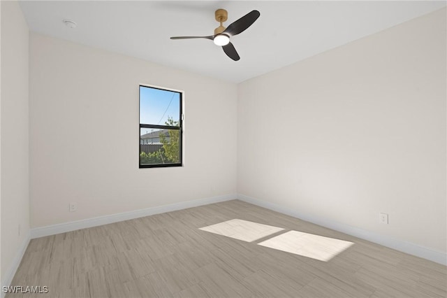 empty room featuring ceiling fan and light hardwood / wood-style floors