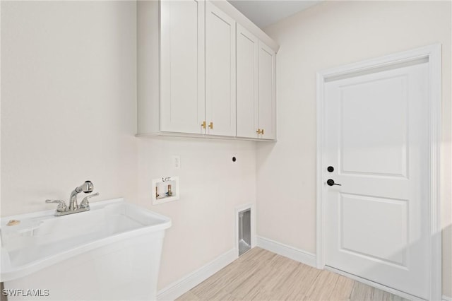 washroom featuring sink, hookup for a washing machine, cabinets, and hookup for an electric dryer