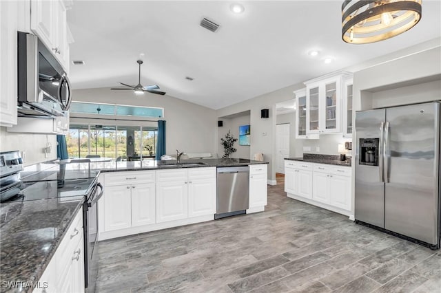 kitchen featuring sink, white cabinetry, dark stone counters, ceiling fan, and stainless steel appliances