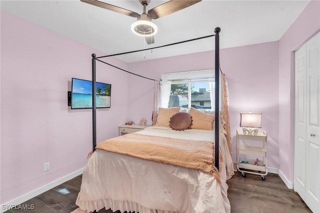 bedroom featuring a closet, baseboards, and wood finished floors