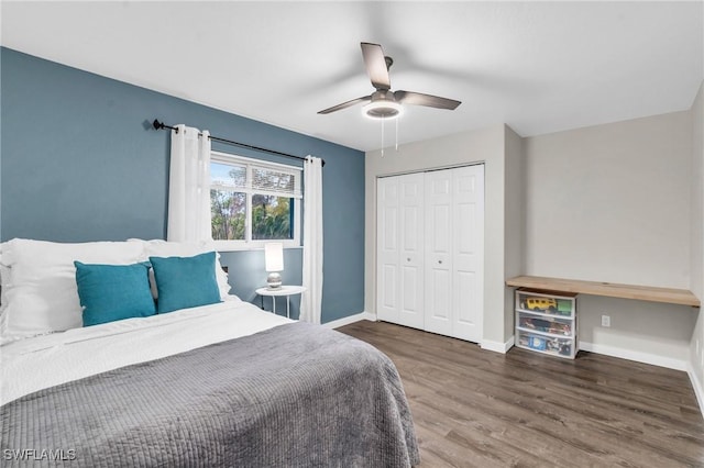 bedroom with a closet, a ceiling fan, baseboards, and wood finished floors