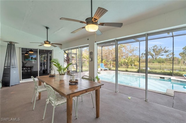 sunroom / solarium featuring ceiling fan