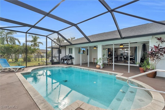 view of pool featuring grilling area, a lanai, ceiling fan, and a patio