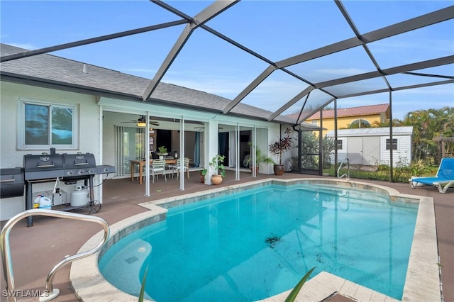 view of swimming pool with grilling area, a patio, a lanai, and ceiling fan