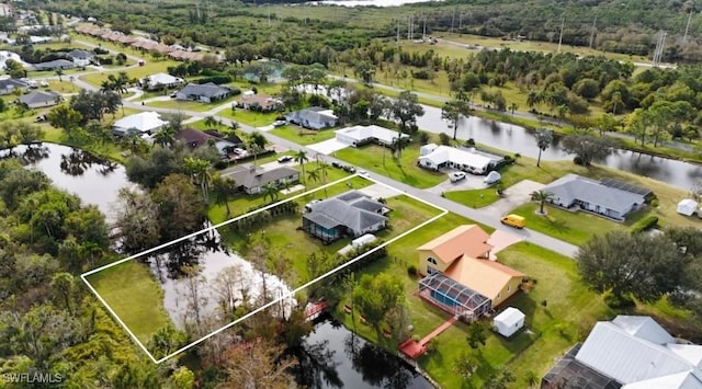 birds eye view of property featuring a residential view and a water view