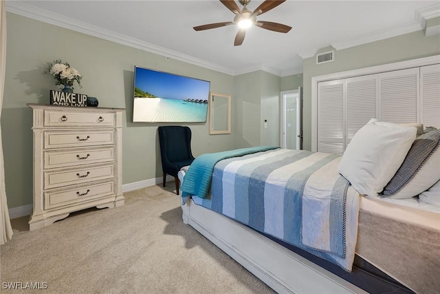 bedroom featuring a closet, ceiling fan, crown molding, and light colored carpet