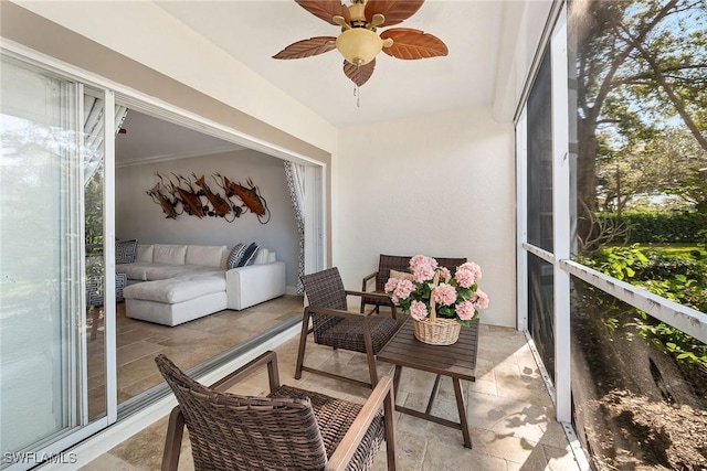 sunroom featuring ceiling fan