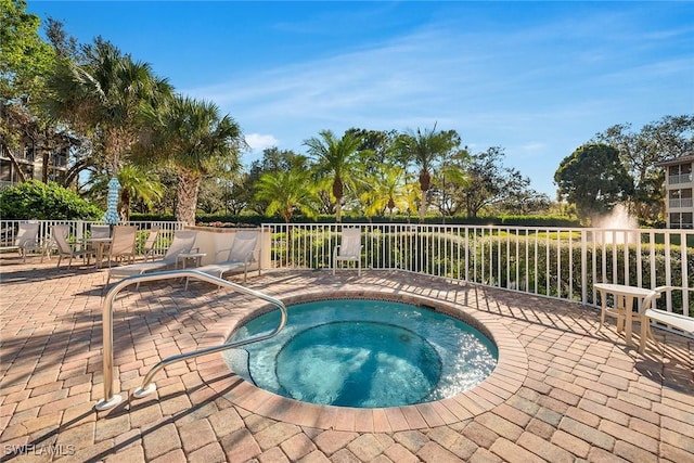 view of pool featuring a patio area and a hot tub