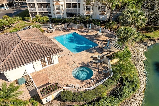 view of swimming pool featuring a patio area and a water view